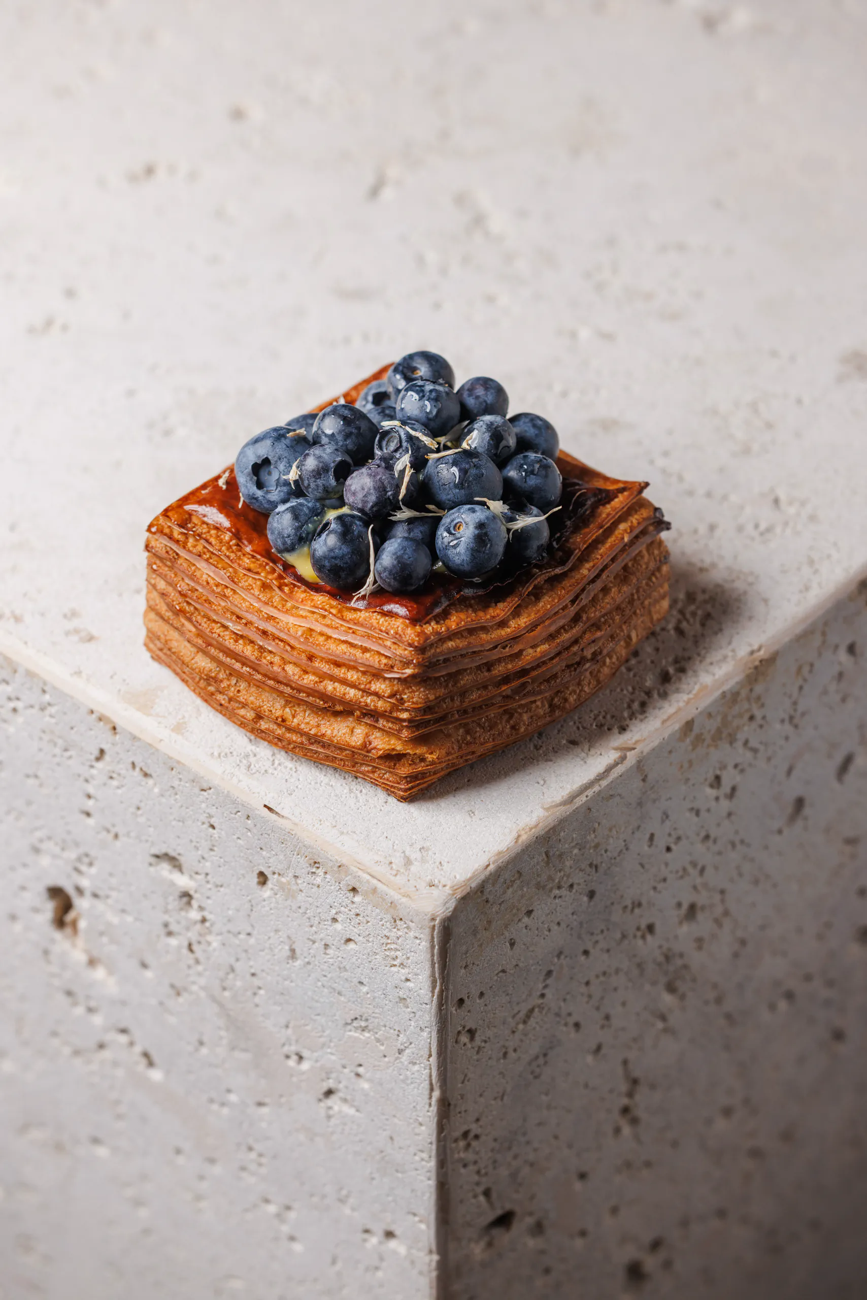 Blueberry mille-feuille pastry on a stone plinth - SEU Pizza, Rome, Italy