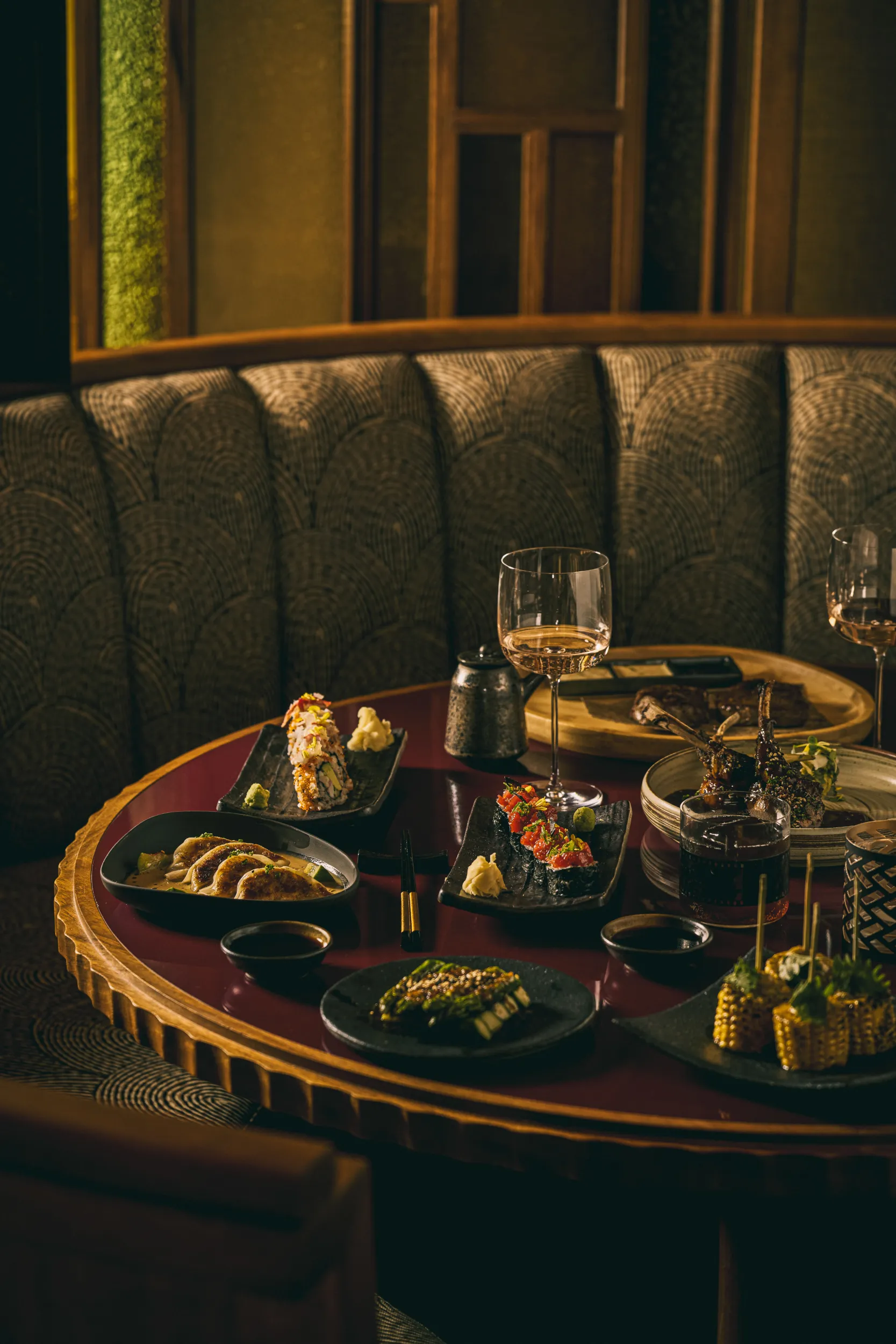 Moody booth table set with an array of small dishes - Mimi Kakushi, Delano Miami, US