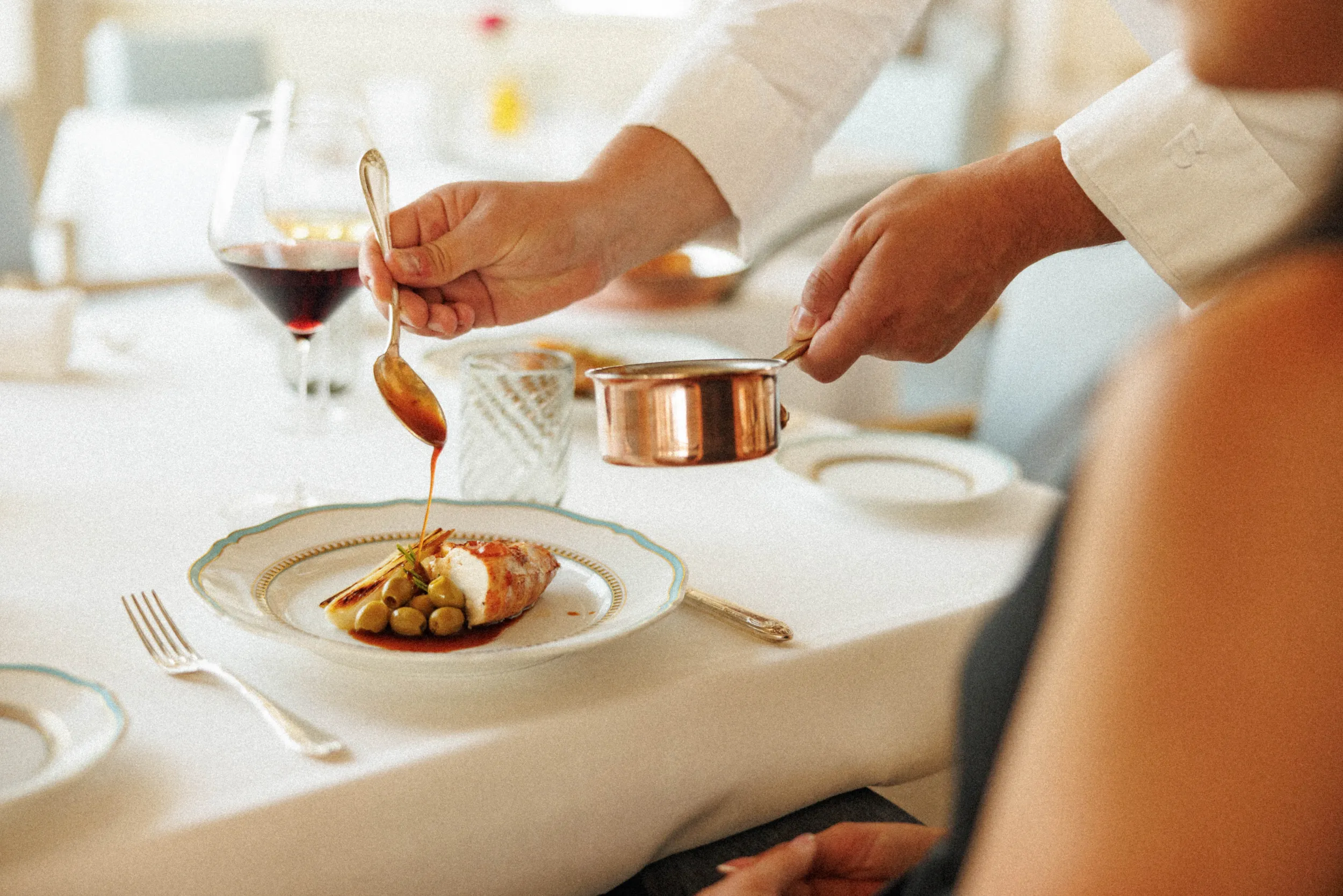 Tableside sauce service over a plated dish with red wine - Four Seasons Danieli, Venice, Italy