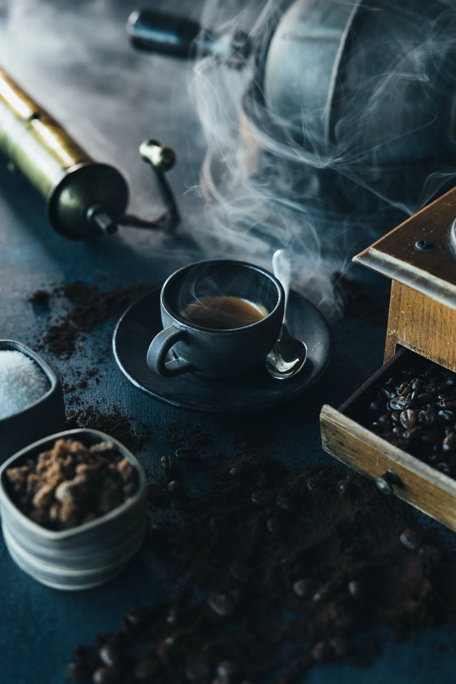 Cup of espresso with a coffee grinder and fresh grounds
